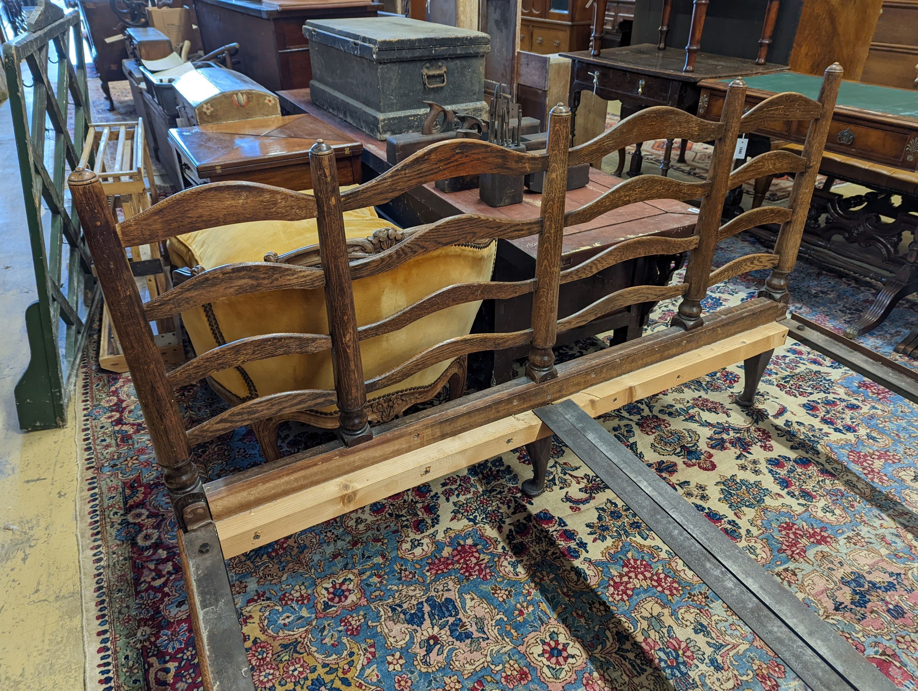 A 1920's oak ladderback double bed frame, width 157cm